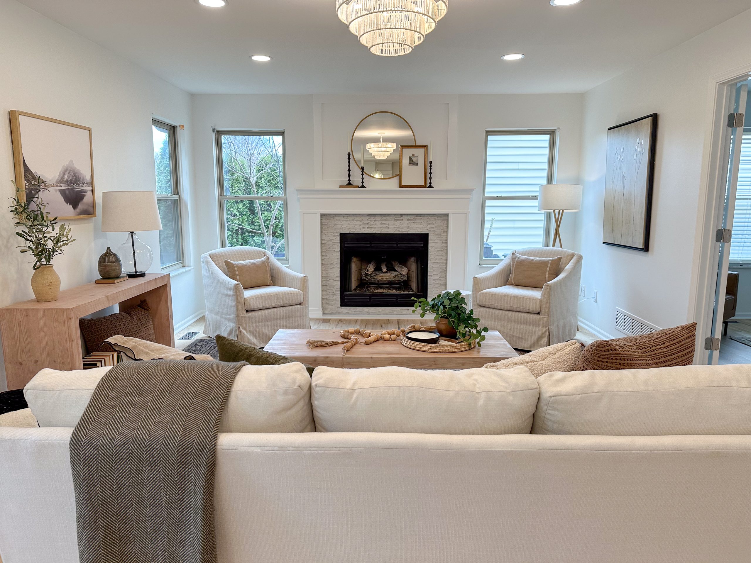 Living room staging in Dublin, Ohio, with white sofa, occasional chairs and stunning fire place mantle.
