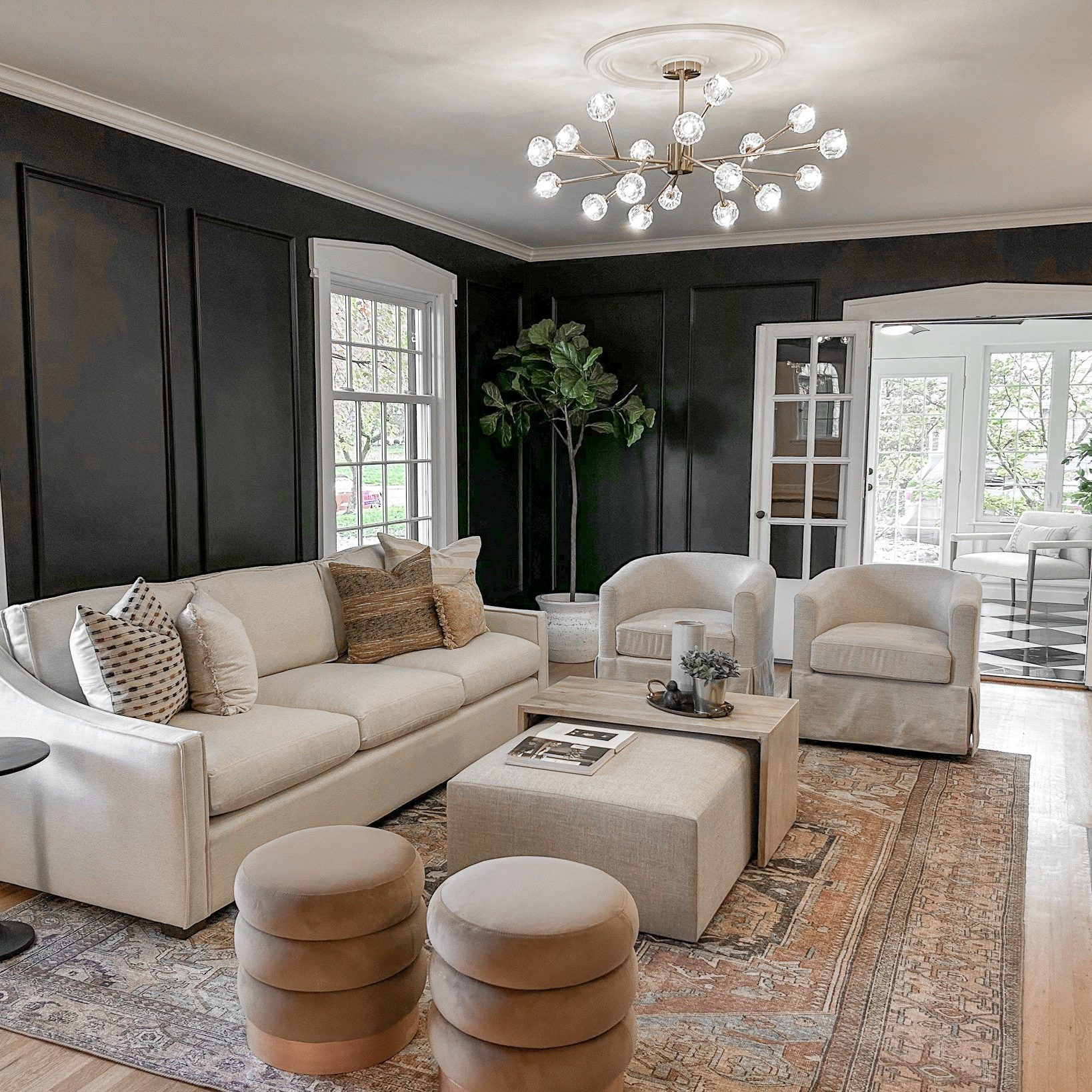 A modernized Upper Arlington home with black walls, modern furniture and large area rug staged before going on the market for sale.