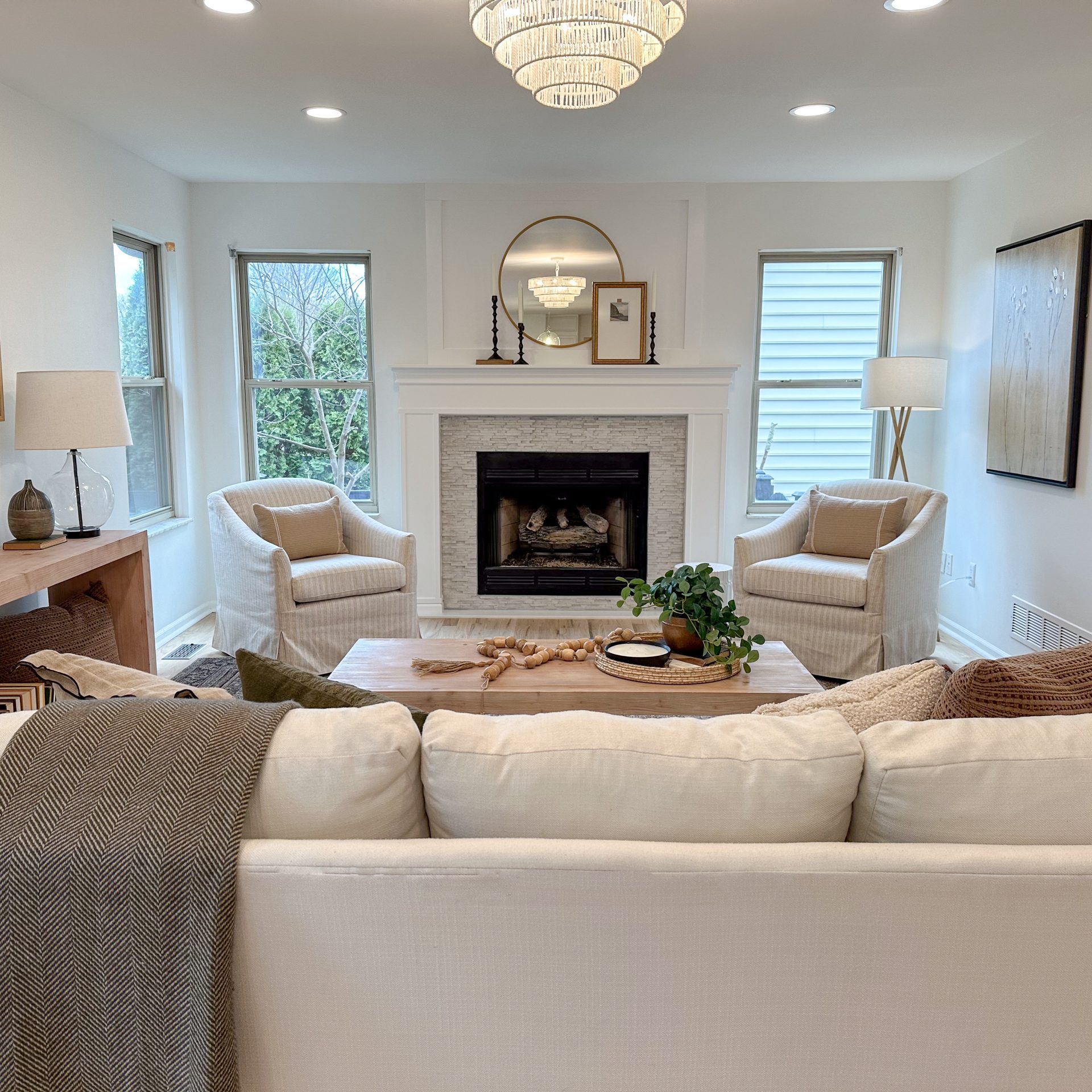Living room staging in Dublin, Ohio, with white sofa, occasional chairs and stunning fire place mantle.